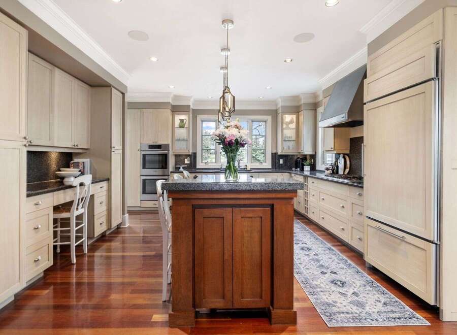 Step into luxury with this stunning kitchen! Featuring a large island, custom cabinetry, and high-end appliances, this space is perfect for both cooking and entertaining.