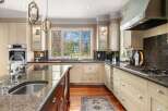 This stunning kitchen boasts a bright and airy design, perfect for culinary enthusiasts.