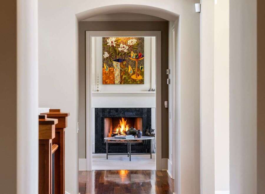 Step into luxury with this stunning property, showcasing a warm and inviting fireplace as the focal point.
