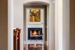 Step into luxury with this stunning property, showcasing a warm and inviting fireplace as the focal point.
