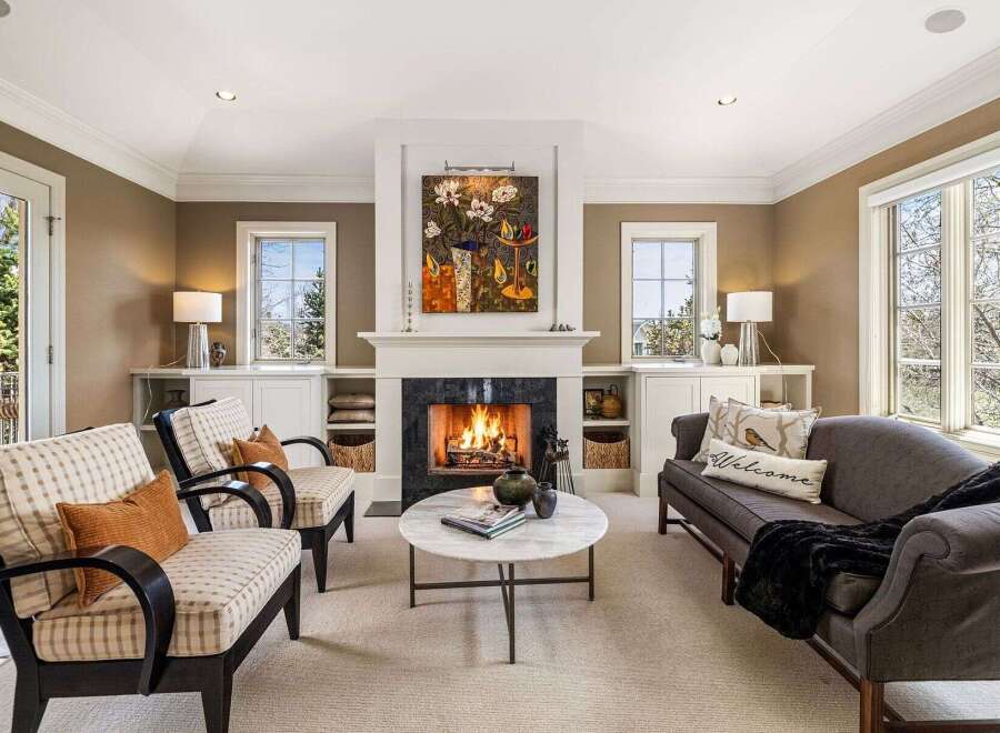 Step into luxury with this stunning living room, featuring a cozy fireplace and elegant seating.