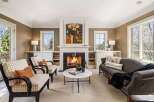 Step into luxury with this stunning living room, featuring a cozy fireplace and elegant seating.
