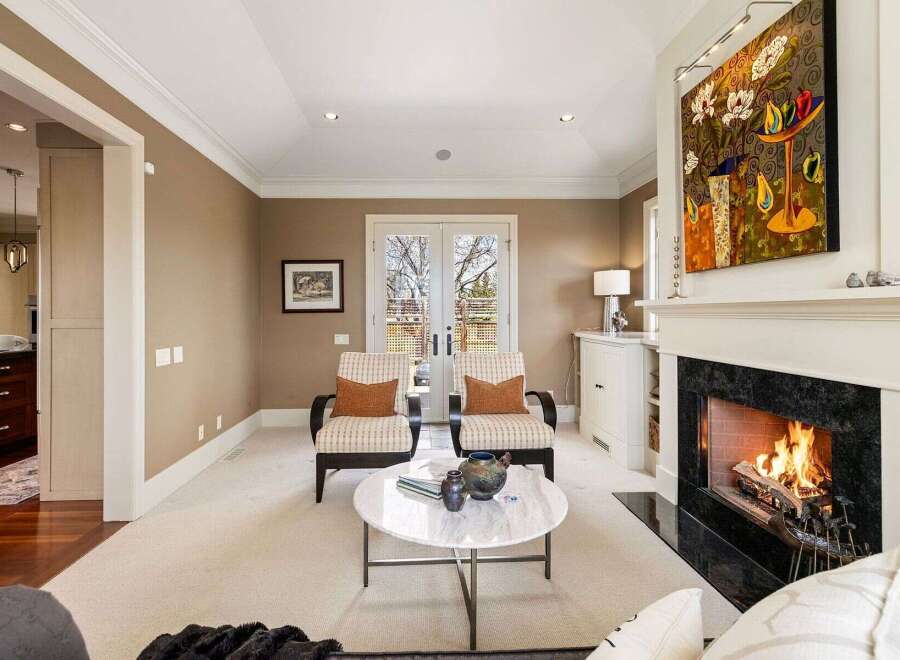 Step into luxury with this stunning living room, featuring a cozy fireplace and elegant seating.