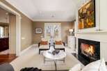 Step into luxury with this stunning living room, featuring a cozy fireplace and elegant seating.