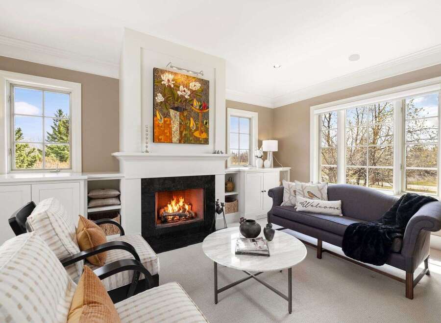 Experience luxury living in this stunning property featuring a cozy fireplace, perfect for chilly evenings.