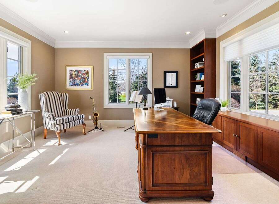 Step into luxury with this stunning home office, featuring a classic design and ample natural light.