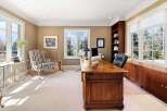 Step into luxury with this stunning home office, featuring a classic design and ample natural light.