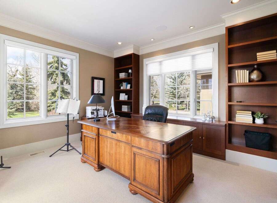 This stunning office space boasts a classic design with rich wood finishes and ample natural light.