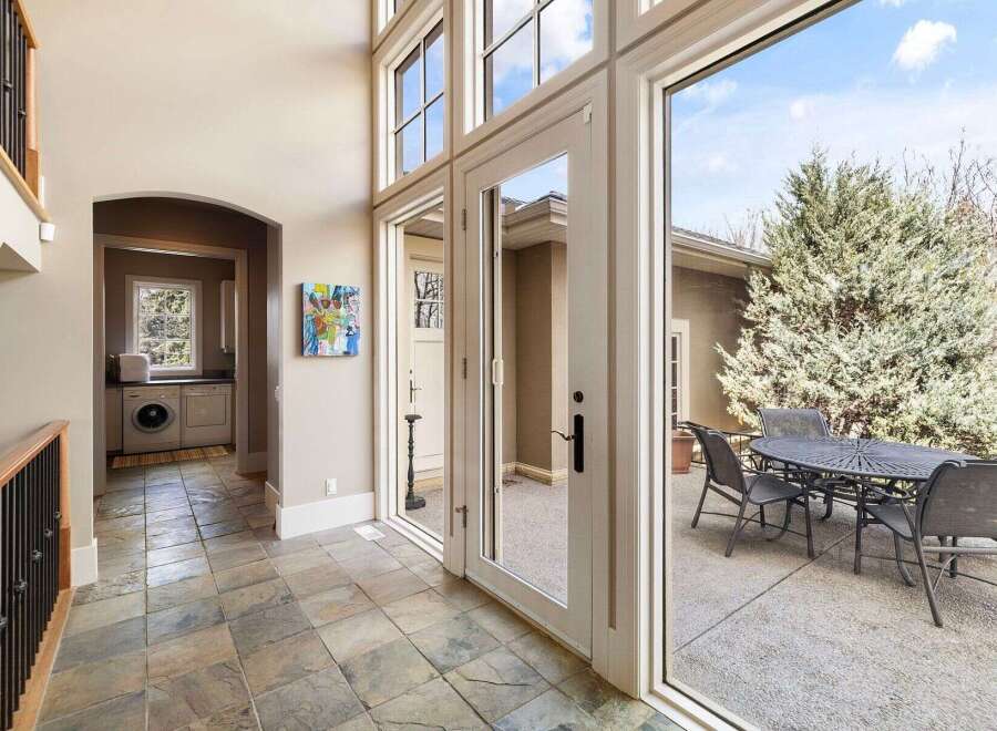 Step into luxury with this stunning property, featuring an inviting entryway that leads to a bright and airy living space.