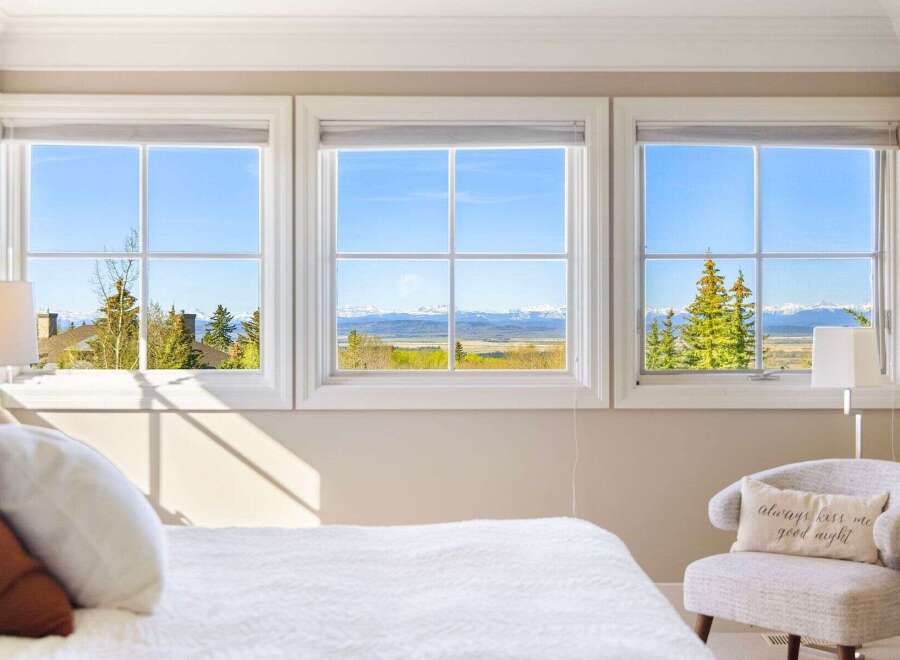 Enjoy breathtaking mountain views from this stunning bedroom.
