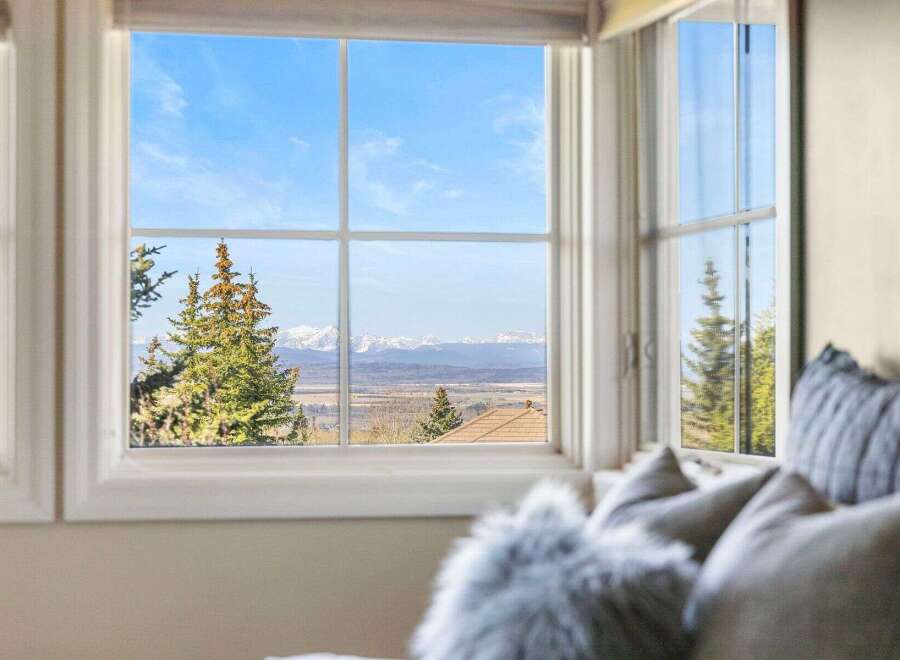 Enjoy breathtaking mountain views from this stunning property! This home offers a serene escape with panoramic vistas visible through large windows.
