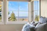 Enjoy breathtaking mountain views from this stunning property! This home offers a serene escape with panoramic vistas visible through large windows.