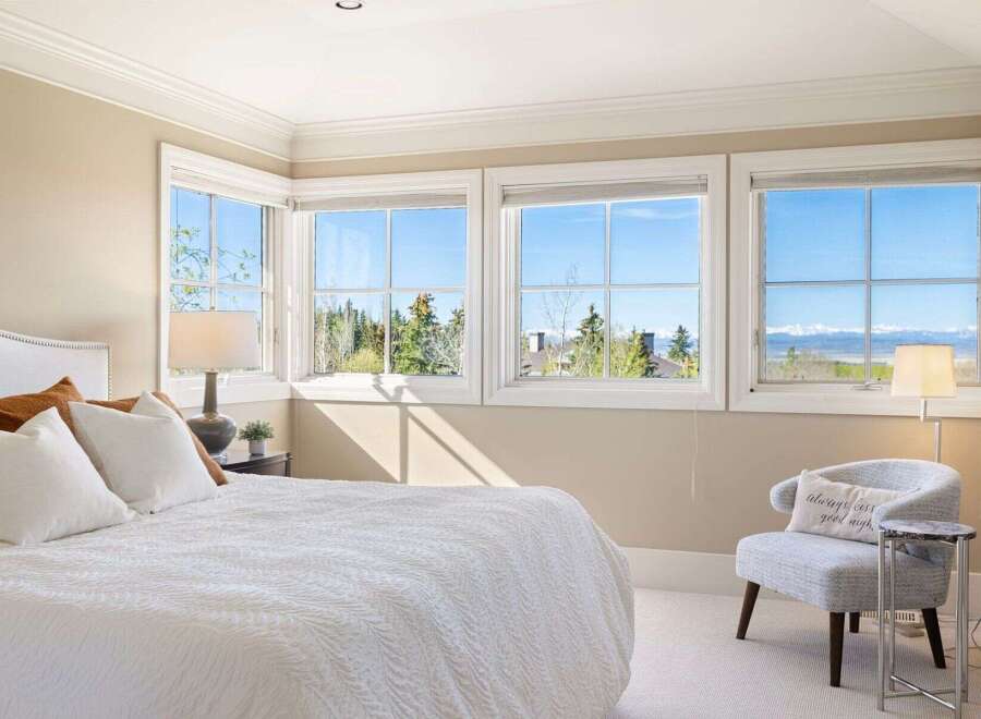 Experience luxury living in this stunning bedroom with breathtaking views.