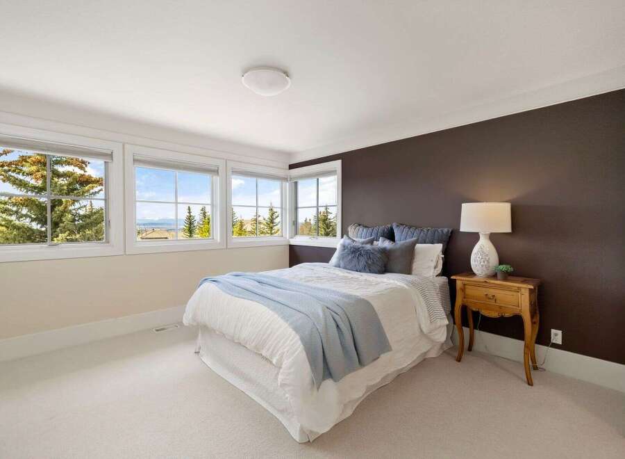 This inviting bedroom features a cozy bed with a light blue throw, perfect for relaxation.