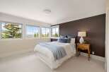 This inviting bedroom features a cozy bed with a light blue throw, perfect for relaxation.