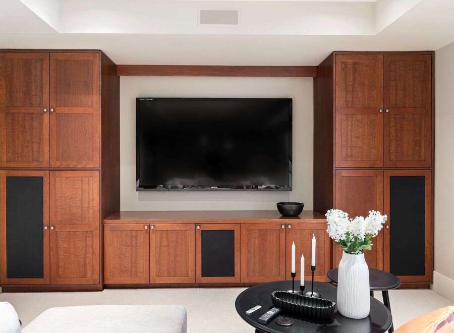 This stunning living space features custom built-in cabinetry, perfect for storage and entertainment.