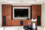This stunning living space features custom built-in cabinetry, perfect for storage and entertainment.