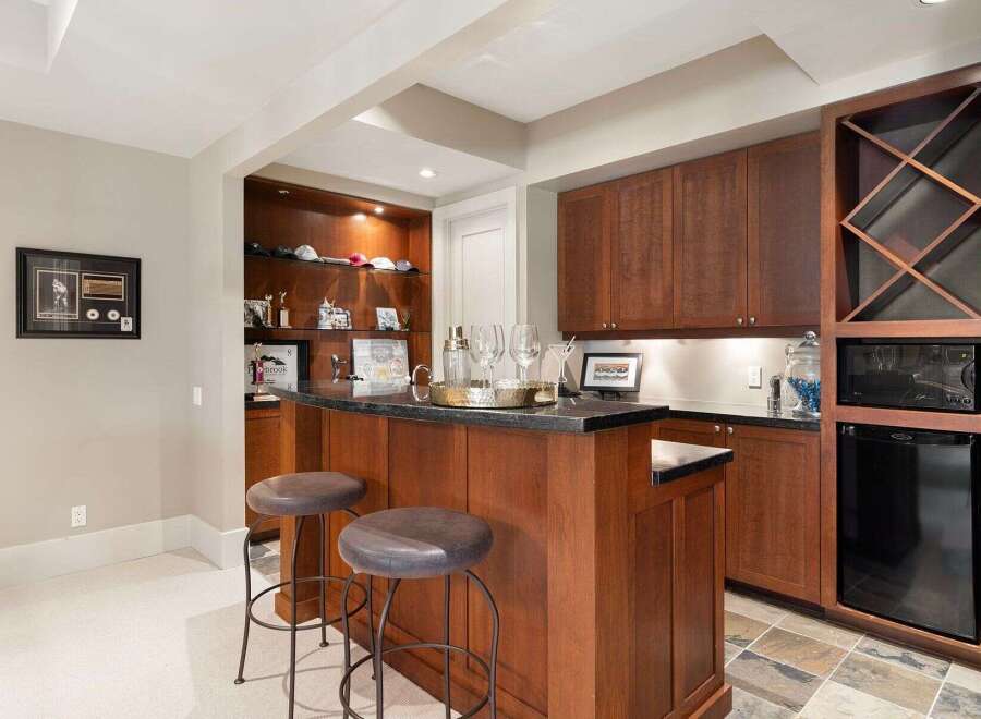 This stunning home features a luxurious bar area, perfect for entertaining guests.