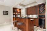 This stunning home features a luxurious bar area, perfect for entertaining guests.