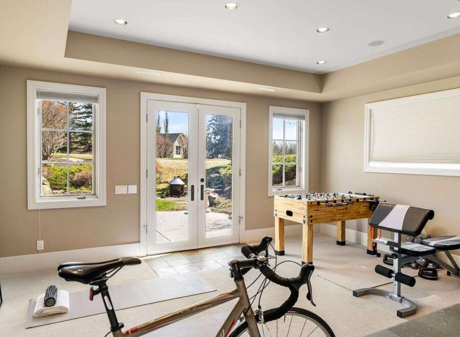 This stunning property boasts a versatile space perfect for both fitness and leisure.