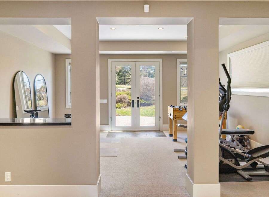 Step into a world of possibilities with this stunning property, featuring a versatile space perfect for a home gym or recreational area.