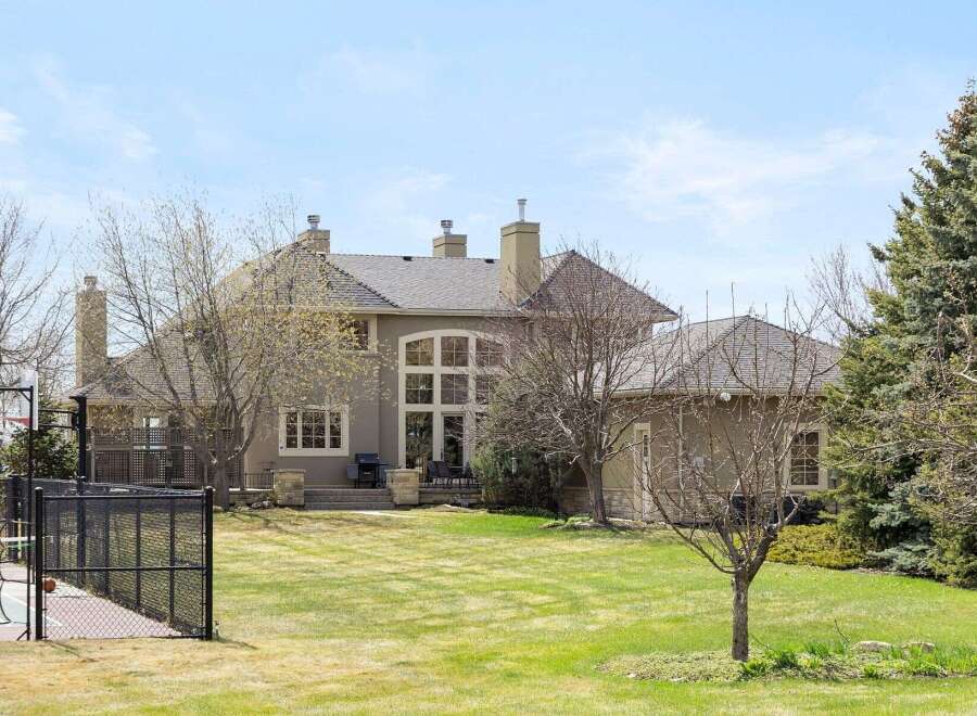 This stunning property boasts a beautifully manicured lawn and a spacious backyard, perfect for outdoor activities.