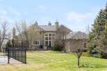 This stunning property boasts a beautifully manicured lawn and a spacious backyard, perfect for outdoor activities.