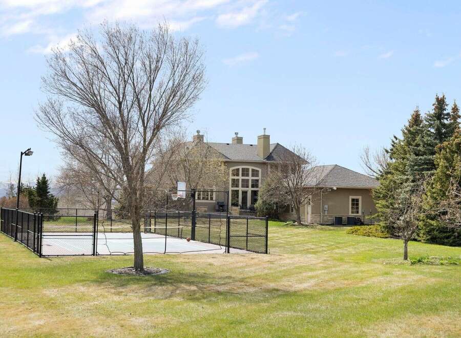 This stunning property boasts a luxurious outdoor basketball court, perfect for sports enthusiasts.