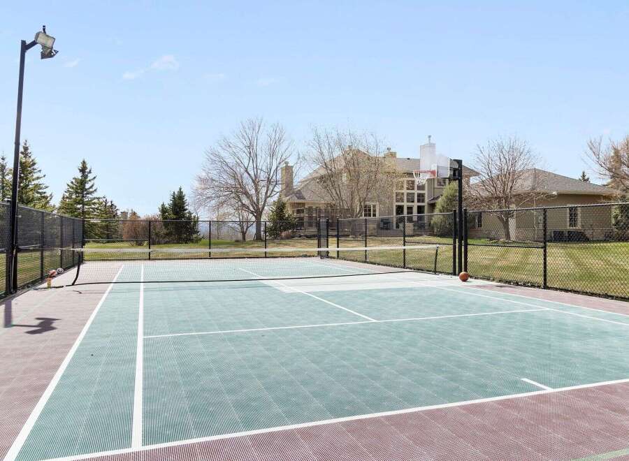 Enjoy luxury living with this stunning property featuring a private tennis court and basketball hoop.
