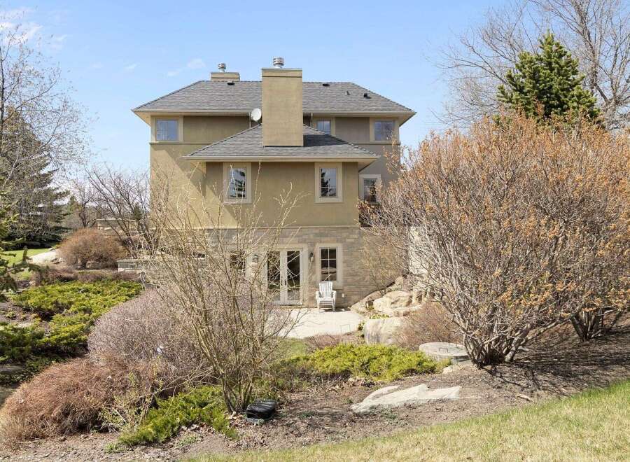 This stunning property boasts a beautiful exterior with a combination of stone and stucco.