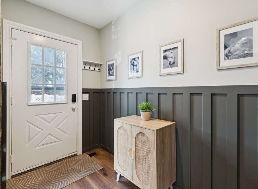 Step into this inviting entryway, showcasing a stylish blend of modern and rustic design.