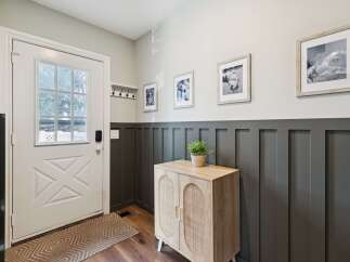 Step into this inviting entryway, showcasing a stylish blend of modern and rustic design.