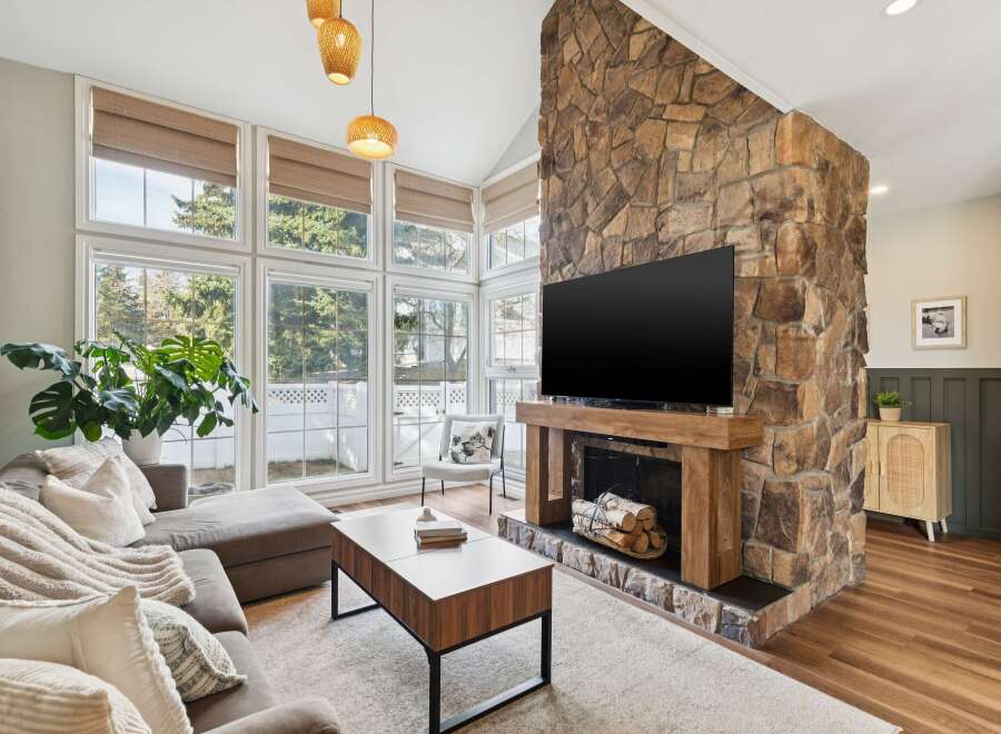 This stunning living room boasts a beautiful stone fireplace, perfect for cozy evenings.