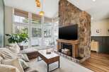 This stunning living room boasts a beautiful stone fireplace, perfect for cozy evenings.