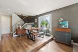 Step into this stunning home featuring a modern dining area with a stylish wooden table and bench.