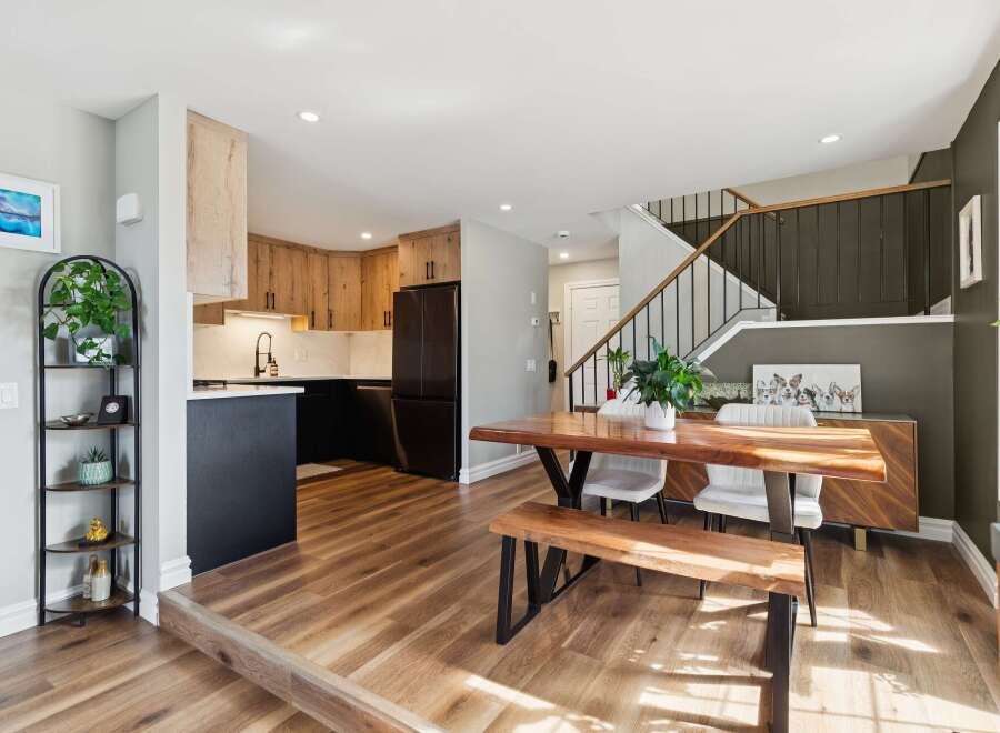 This stunning property features a modern kitchen with sleek black appliances and custom wood cabinetry.