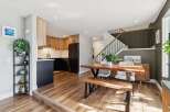 This stunning property features a modern kitchen with sleek black appliances and custom wood cabinetry.