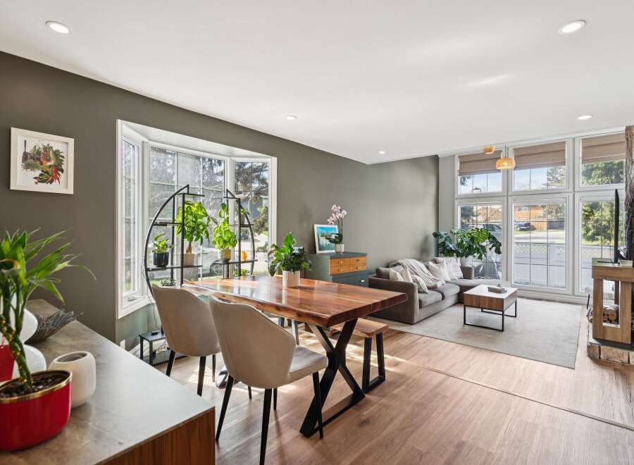 Step into this stunning living space, featuring a modern dining area with a stylish wooden table and chairs.