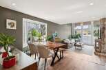 Step into this stunning living space, featuring a modern dining area with a stylish wooden table and chairs.