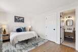 Step into this inviting bedroom, featuring a cozy bed adorned with plush pillows and a stylish rug.