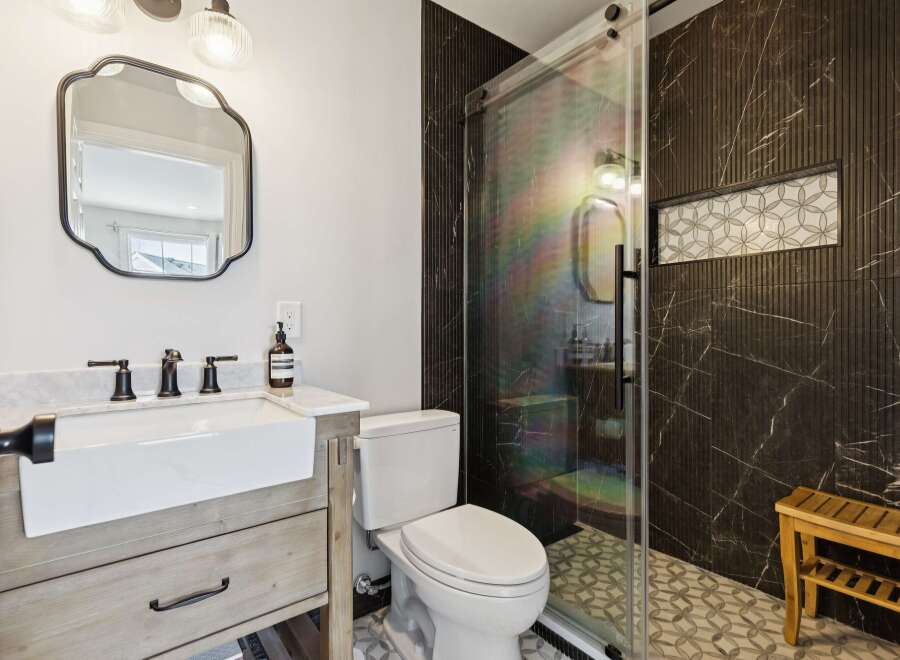 Step into luxury with this stunning bathroom! Featuring a modern vanity, sleek fixtures, and a glass-enclosed shower, this space is designed for both style and functionality.
