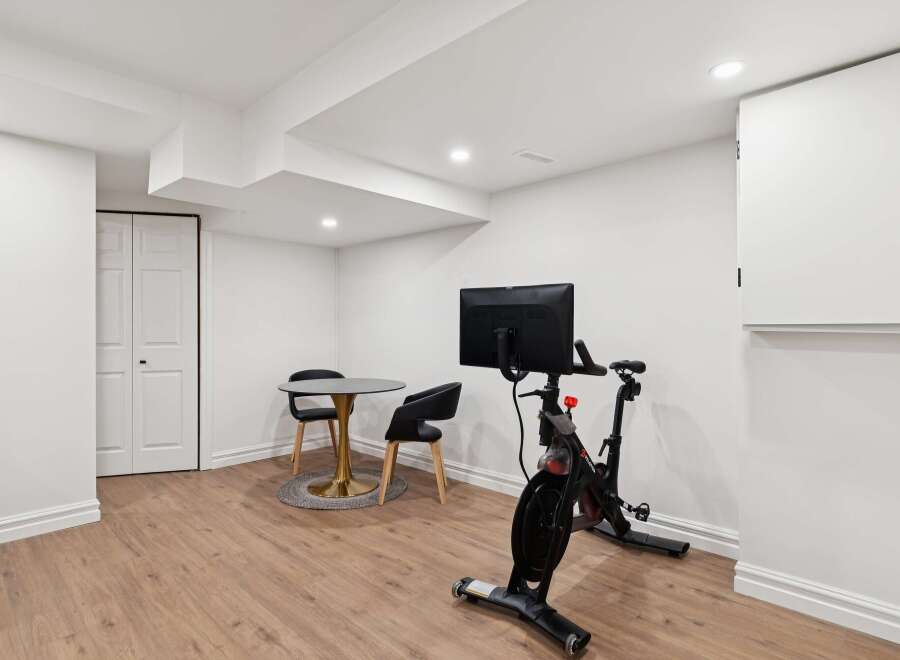 This modern space features a sleek Peloton bike, perfect for a home workout.