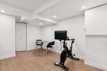 This modern space features a sleek Peloton bike, perfect for a home workout.