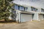 This beautiful property features a modern design with a light blue exterior and a two-car garage.
