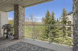 Enjoy breathtaking views from this stunning property! This home features a spacious balcony with a modern glass railing, perfect for relaxing and entertaining.