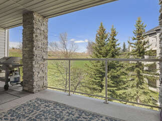 Enjoy breathtaking views from this stunning property! This home features a spacious balcony with a modern glass railing, perfect for relaxing and entertaining.