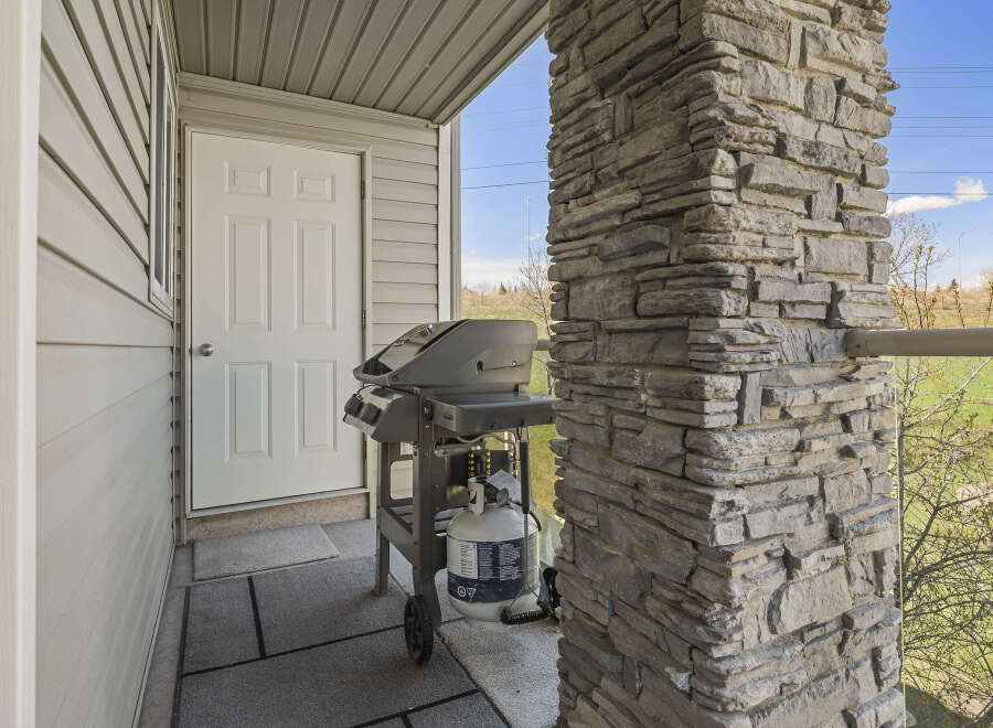 Enjoy outdoor cooking with this charming property featuring a convenient grill setup on the porch.