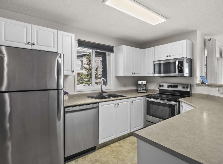 This stunning kitchen boasts modern appliances and ample counter space, perfect for culinary enthusiasts.