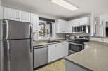 This stunning kitchen boasts modern appliances and ample counter space, perfect for culinary enthusiasts.