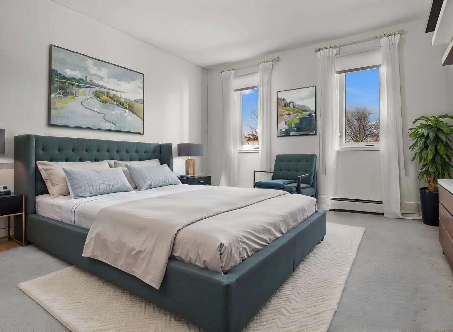 Step into this serene bedroom, featuring a plush, tufted headboard and a calming color palette.